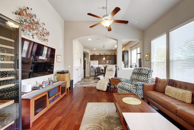 3808 Mattie St, Austin, TX 78723 - living room featuring wood finished floors, a ceiling fan, arched walkways, and high vaulted ceiling