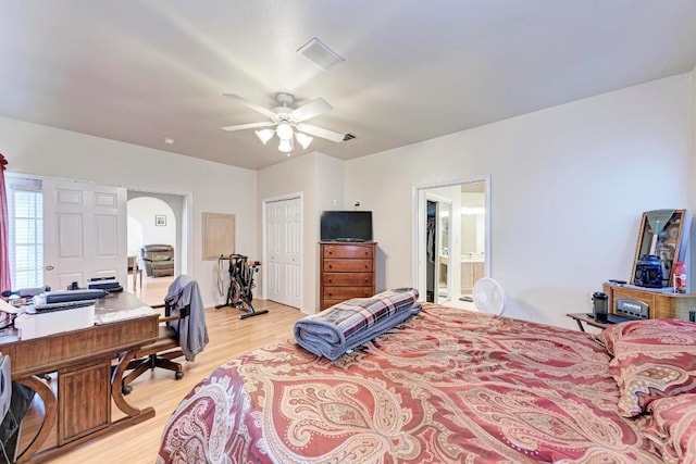 1610 Meadow Ln, Lockhart, TX 78644 - bedroom with light wood-style floors, an office area, arched walkways, a closet, and ensuite bath
