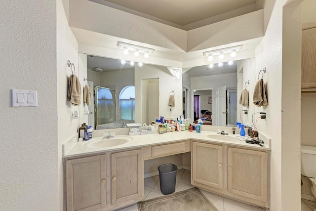 1610 Meadow Ln, Lockhart, TX 78644 - full bathroom with a textured wall, double vanity, tile patterned flooring, and a shower