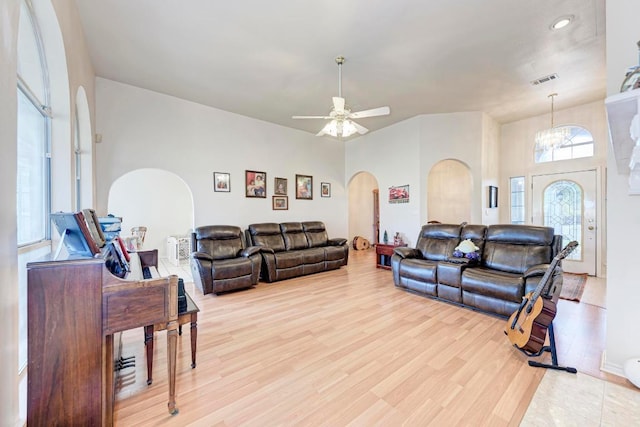 1610 Meadow Ln, Lockhart, TX 78644 - living room featuring arched walkways, light wood-type flooring, ceiling fan, and a chandelier