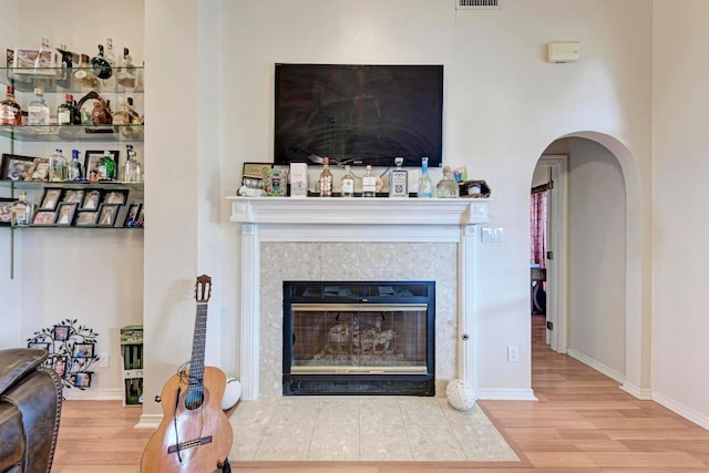 1610 Meadow Ln, Lockhart, TX 78644 - living room featuring wood finished floors, arched walkways, and a fireplace