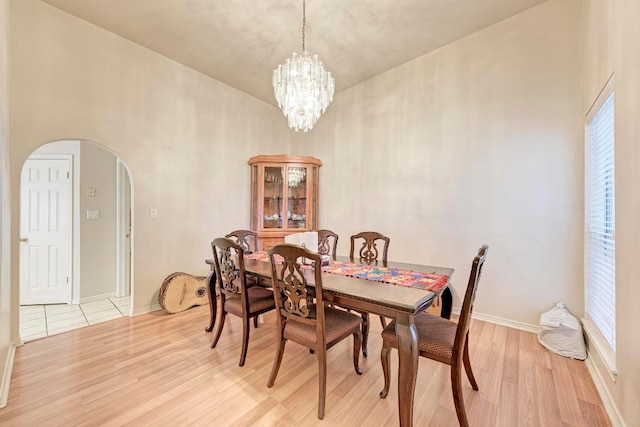 1610 Meadow Ln, Lockhart, TX 78644 - dining space featuring arched walkways, light wood finished floors, and a chandelier