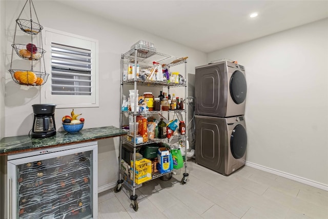 6903 Moonmont Dr, Austin, TX 78745 - laundry area with stacked washing machine and dryer, wine cooler, baseboards, and recessed lighting