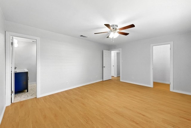 6903 Moonmont Dr, Austin, TX 78745 - unfurnished bedroom featuring light wood-style flooring, a spacious closet, baseboards, and ceiling fan