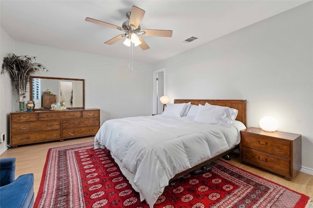 6903 Moonmont Dr, Austin, TX 78745 - bedroom with wood finished floors, a ceiling fan, and baseboards