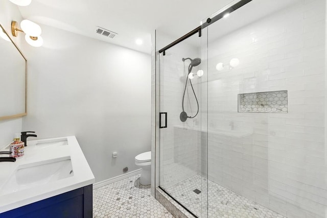 6903 Moonmont Dr, Austin, TX 78745 - bathroom featuring double vanity, a stall shower, baseboards, tile patterned flooring, and toilet