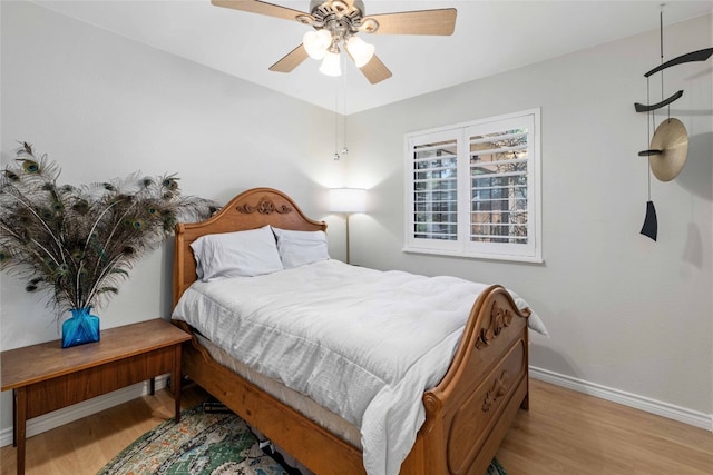 6903 Moonmont Dr, Austin, TX 78745 - bedroom with baseboards, wood finished floors, and ceiling fan