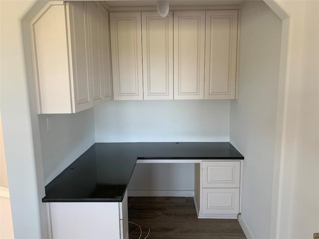 4102 Glendale Ln, Lago Vista, TX 78645 - kitchen with dark countertops, dark wood-style floors, and white cabinetry