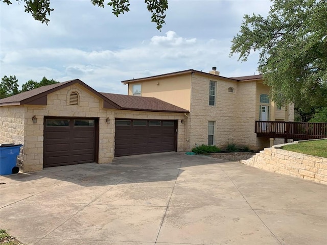 4102 Glendale Ln, Lago Vista, TX 78645 - view of front of property with stone siding, a garage, and driveway