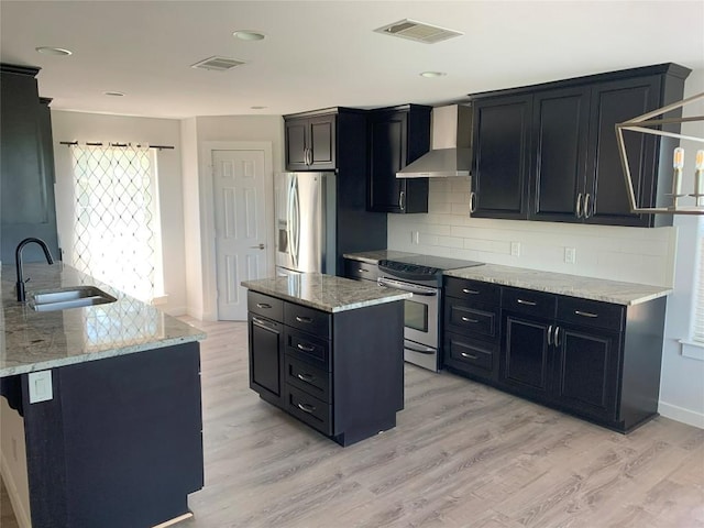 4102 Glendale Ln, Lago Vista, TX 78645 - kitchen with appliances with stainless steel finishes, wall chimney range hood, dark cabinetry, light wood-style floors, and recessed lighting