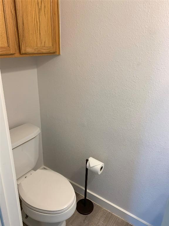 4102 Glendale Ln, Lago Vista, TX 78645 - bathroom featuring wood finished floors and toilet