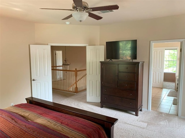 1813 Country Squire Dr, Cedar Park, TX 78613 - bedroom with light carpet, light tile patterned floors, and a ceiling fan