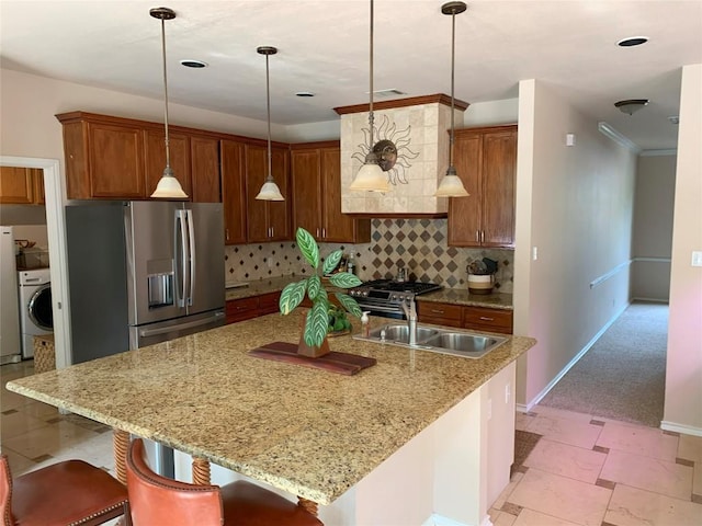 1813 Country Squire Dr, Cedar Park, TX 78613 - kitchen with washer / dryer, appliances with stainless steel finishes, decorative backsplash, hanging light fixtures, and light stone countertops