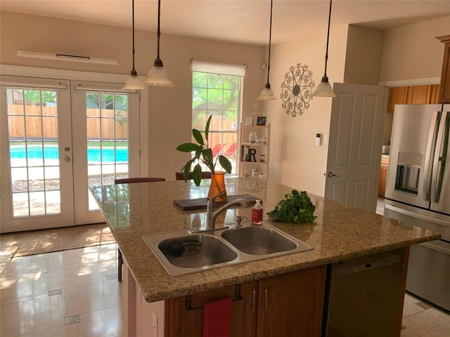 1813 Country Squire Dr, Cedar Park, TX 78613 - kitchen with stainless steel appliances, a center island with sink, french doors, pendant lighting, and brown cabinets