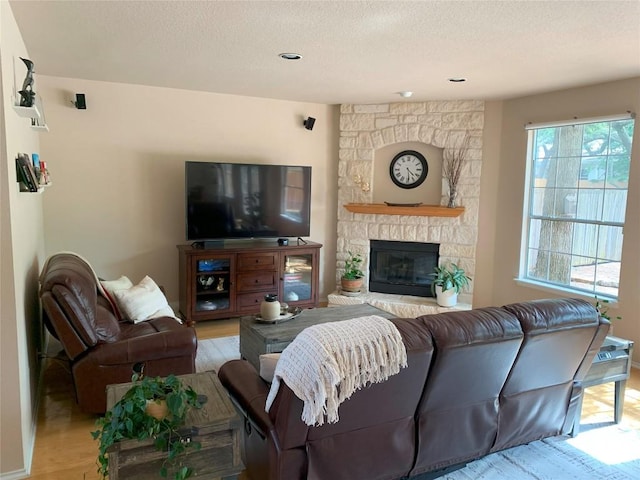 1813 Country Squire Dr, Cedar Park, TX 78613 - living room featuring light wood finished floors, a textured ceiling, and a fireplace