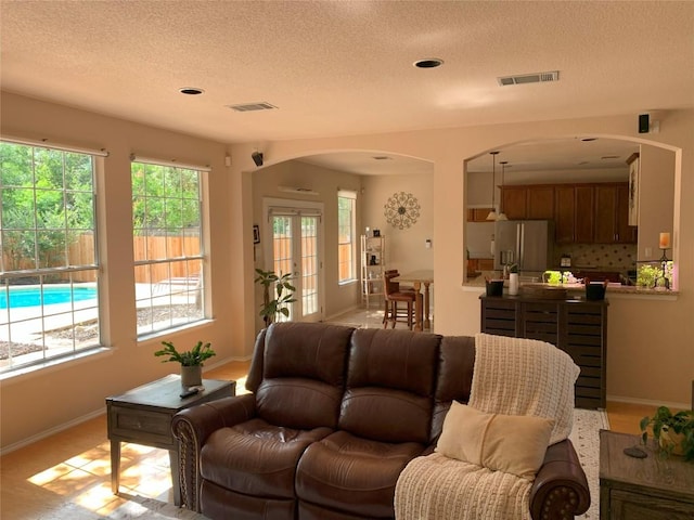 1813 Country Squire Dr, Cedar Park, TX 78613 - living area with arched walkways and a textured ceiling