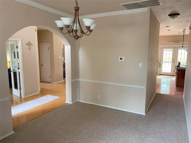1813 Country Squire Dr, Cedar Park, TX 78613 - unfurnished room featuring arched walkways, light colored carpet, a chandelier, and crown molding
