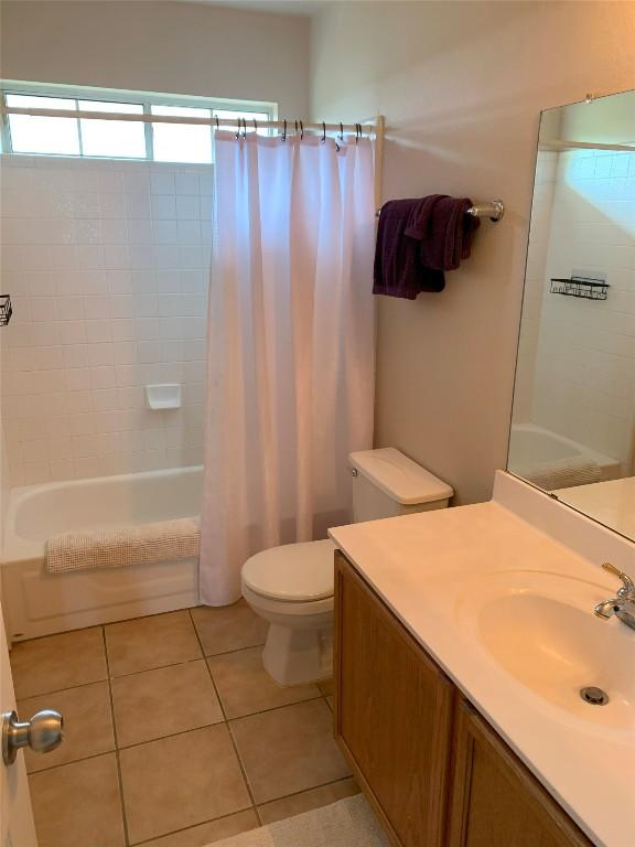 1813 Country Squire Dr, Cedar Park, TX 78613 - bathroom featuring vanity, shower / bath combo with shower curtain, and tile patterned floors