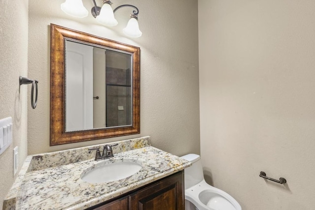 25036 River Rd, Spicewood, TX 78669 - bathroom featuring vanity, toilet, and a textured wall