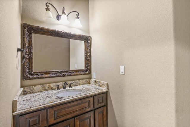 25036 River Rd, Spicewood, TX 78669 - bathroom with vanity and a textured wall