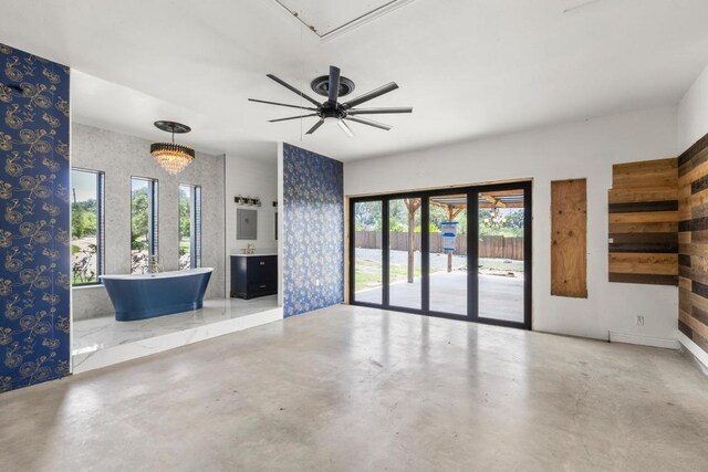 25036 River Rd, Spicewood, TX 78669 - unfurnished living room featuring concrete floors and a ceiling fan