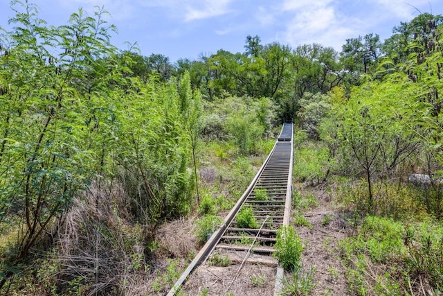25036 River Rd, Spicewood, TX 78669 - view of home's community featuring stairway and a wooded view