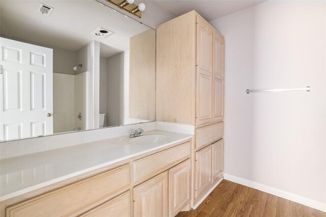2509 Riddle Rd, Austin, TX 78748 - full bath featuring vanity, wood finished floors, toilet, baseboards, and  shower combination