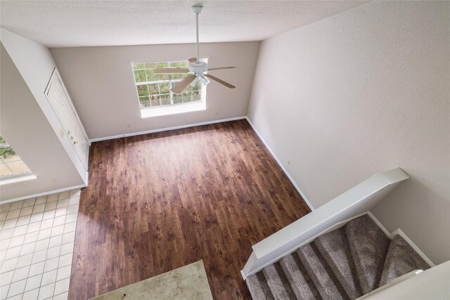2509 Riddle Rd, Austin, TX 78748 - unfurnished dining area featuring ceiling fan, baseboards, stairs, and wood finished floors