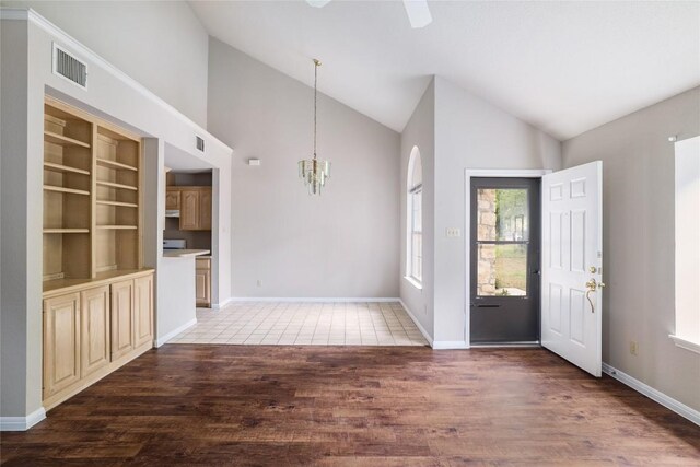 2509 Riddle Rd, Austin, TX 78748 - entrance foyer with a chandelier, wood finished floors, high vaulted ceiling, ceiling fan, and baseboards