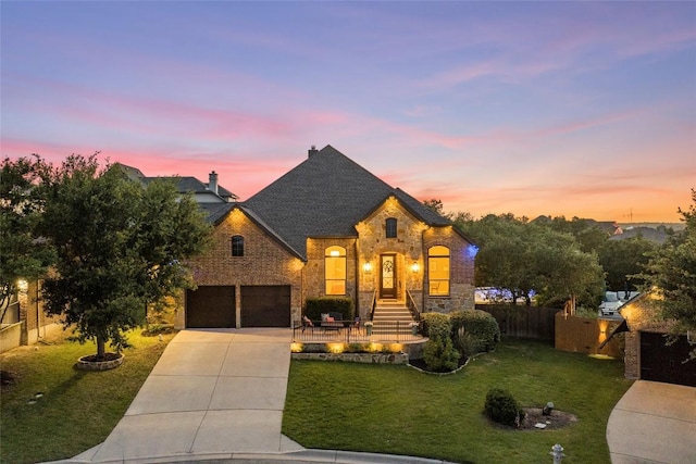 405 Mirafield Ln, Austin, TX 78737 - french provincial home with concrete driveway, a garage, stone siding, and roof with shingles