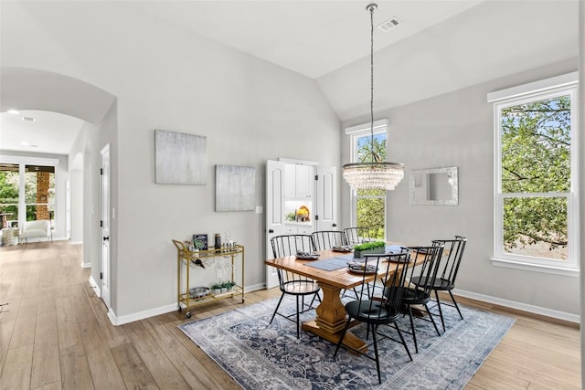 405 Mirafield Ln, Austin, TX 78737 - dining space with high vaulted ceiling, arched walkways, baseboards, light wood-type flooring, and healthy amount of natural light