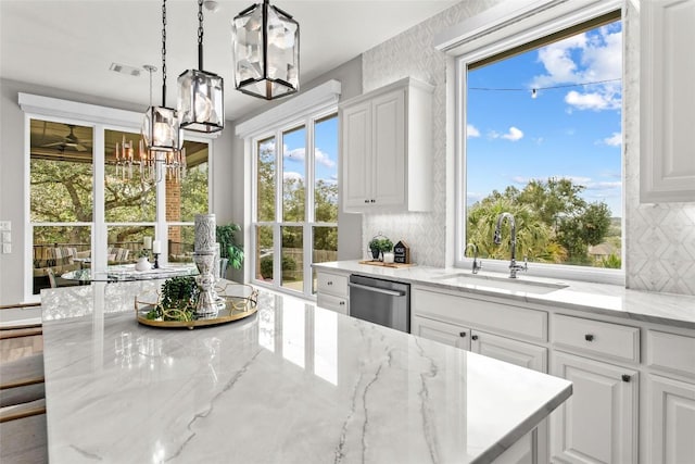 405 Mirafield Ln, Austin, TX 78737 - kitchen with a sink, dishwasher, a chandelier, and healthy amount of natural light