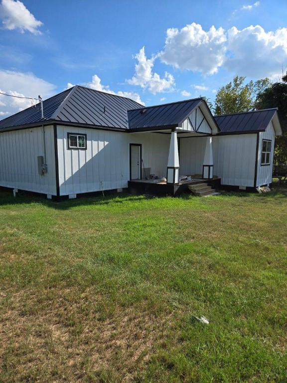 1525 Waco St, Gonzales, TX 78629 - back of property with a metal roof and a yard