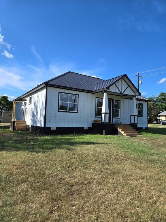 1525 Waco St, Gonzales, TX 78629 - view of front of house featuring a front yard, a metal roof, and board and batten siding
