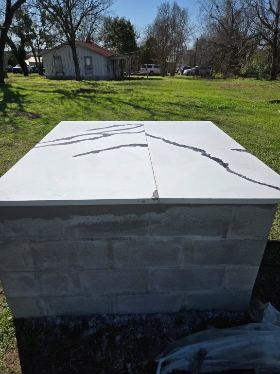 1525 Waco St, Gonzales, TX 78629 - view of storm shelter featuring a lawn