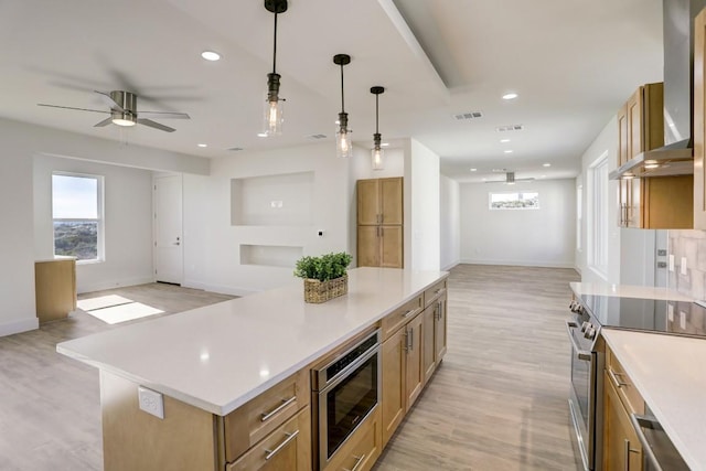 4300 Mansfield Dam Rd Unit 1131, Austin, TX 78734 - kitchen with open floor plan, stainless steel appliances, wall chimney range hood, light wood-type flooring, and recessed lighting