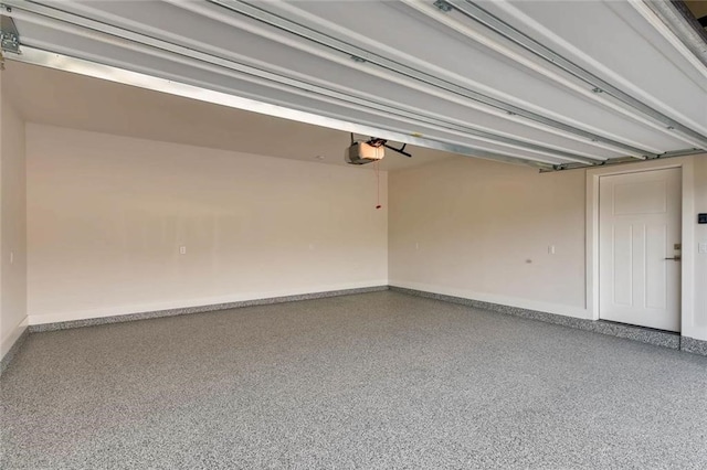4300 Mansfield Dam Rd Unit 1131, Austin, TX 78734 - garage featuring a garage door opener and baseboards
