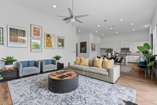 5324 Agatha Cir, Austin, TX 78724 - living area featuring recessed lighting, a high ceiling, light wood-style flooring, and a ceiling fan