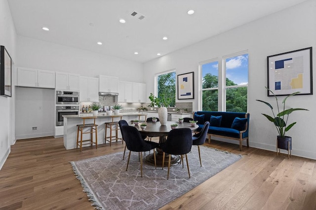 5324 Agatha Cir, Austin, TX 78724 - dining space with recessed lighting, light wood finished floors, baseboards, and a towering ceiling