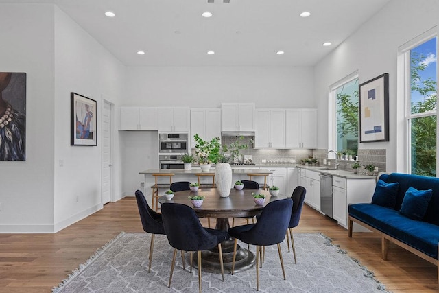 5324 Agatha Cir, Austin, TX 78724 - dining space featuring recessed lighting, light wood finished floors, and a high ceiling