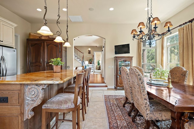 1607 The High Rd, Austin, TX 78746 - dining area with arched walkways, a chandelier, light tile patterned flooring, stairs, and recessed lighting