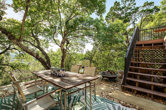 1607 The High Rd, Austin, TX 78746 - view of patio / terrace featuring stairs, outdoor dining space, and a fire pit