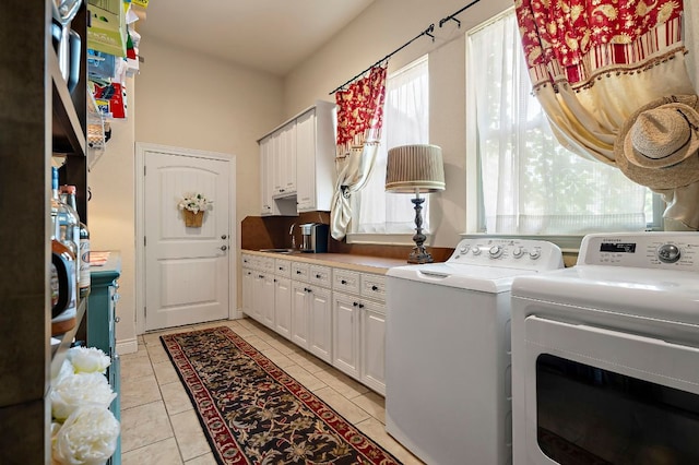 1607 The High Rd, Austin, TX 78746 - washroom featuring washer and dryer, cabinet space, and light tile patterned floors