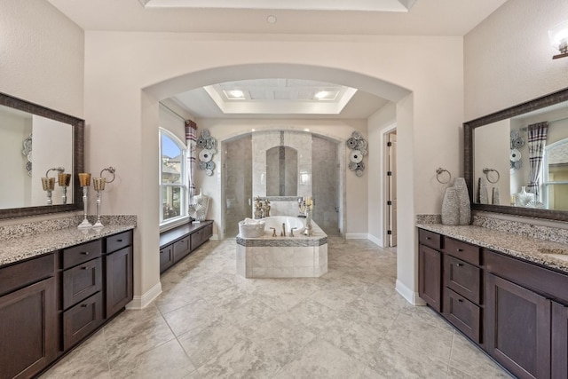 2329 Sandorna Ct, Leander, TX 78641 - full bath featuring a tray ceiling, a bath, two vanities, and a shower stall