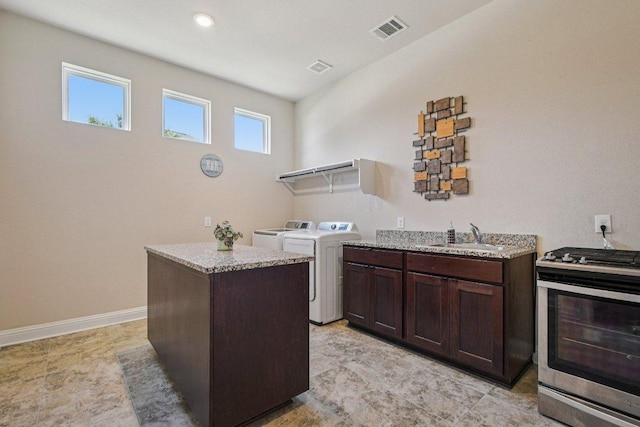 2329 Sandorna Ct, Leander, TX 78641 - washroom with washer and dryer and baseboards