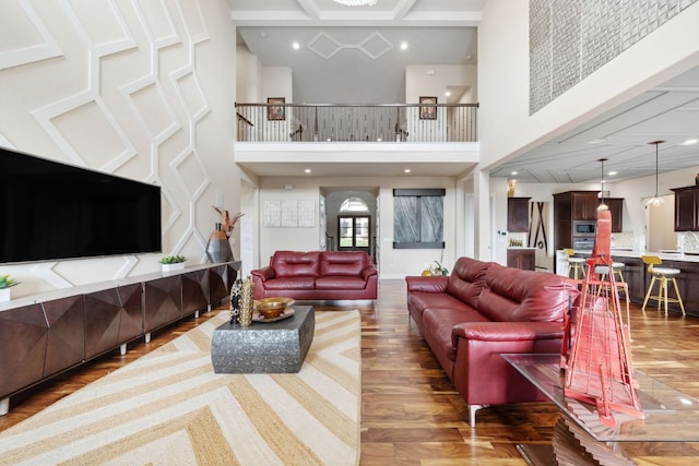 2329 Sandorna Ct, Leander, TX 78641 - living area with a towering ceiling, coffered ceiling, wood finished floors, and recessed lighting