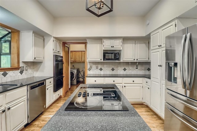 213 Hurst Creek Rd, Austin, TX 78734 - kitchen with black appliances, dark countertops, and tasteful backsplash