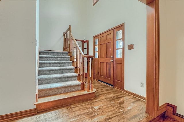 213 Hurst Creek Rd, Austin, TX 78734 - entrance foyer with wood finished floors, stairway, and baseboards