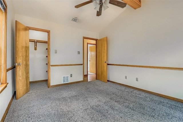 213 Hurst Creek Rd, Austin, TX 78734 - unfurnished bedroom with carpet flooring, vaulted ceiling, a walk in closet, a ceiling fan, and baseboards