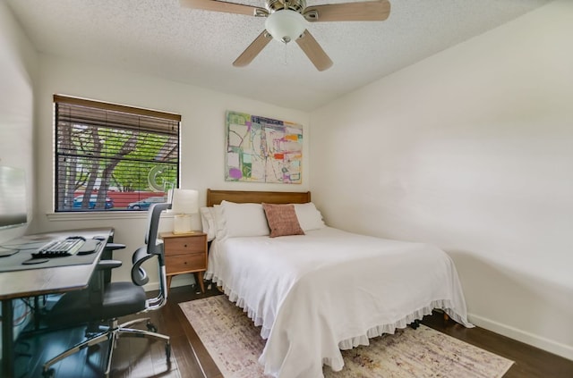 7000 Shadywood Dr, Austin, TX 78745 - bedroom with dark wood-style floors, an office area, a textured ceiling, and ceiling fan